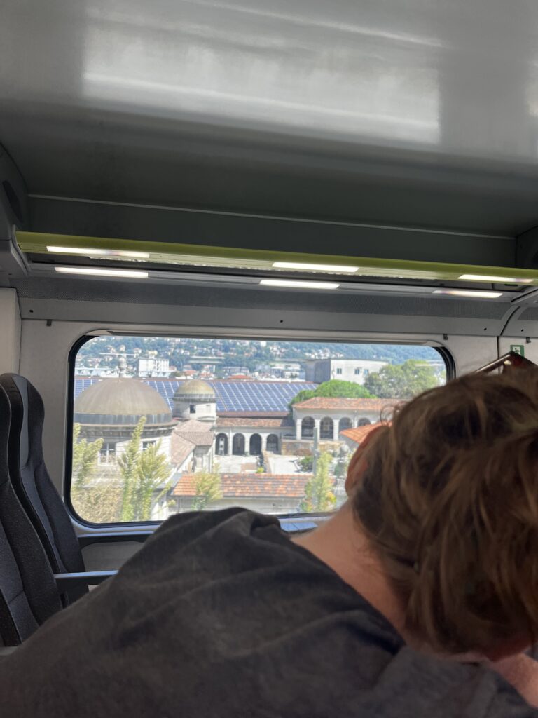 My friend looking out the window on a bus in Milan